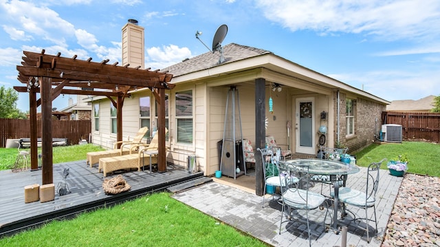 back of property with central AC unit, a pergola, a wooden deck, a patio, and a yard