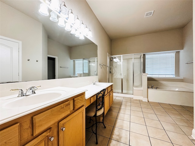 bathroom featuring plus walk in shower, vanity, and tile patterned flooring