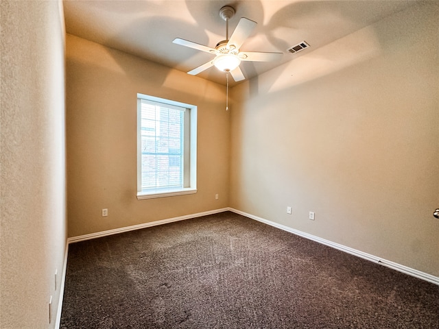 unfurnished room featuring ceiling fan and carpet