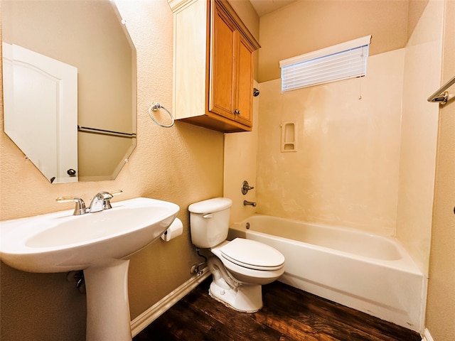 bathroom featuring  shower combination, hardwood / wood-style flooring, and toilet