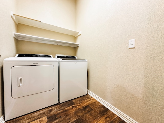 clothes washing area with washing machine and clothes dryer and dark hardwood / wood-style floors