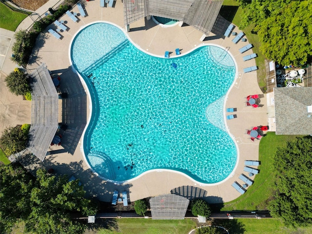 view of swimming pool with a patio area and a yard