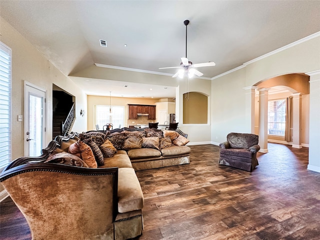 living room featuring dark wood-type flooring, ceiling fan, plenty of natural light, and ornate columns