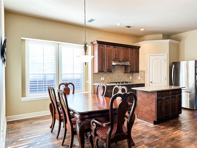 dining room with dark hardwood / wood-style flooring