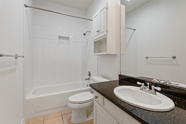 full bathroom featuring toilet, vanity, tiled shower / bath, and tile patterned flooring