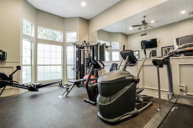 workout area featuring ceiling fan and a textured ceiling