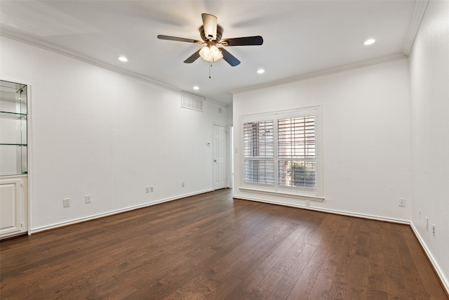 empty room featuring dark wood-type flooring, ceiling fan, and crown molding