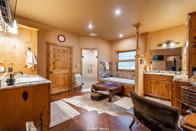 bathroom with concrete flooring, vanity, and a tub