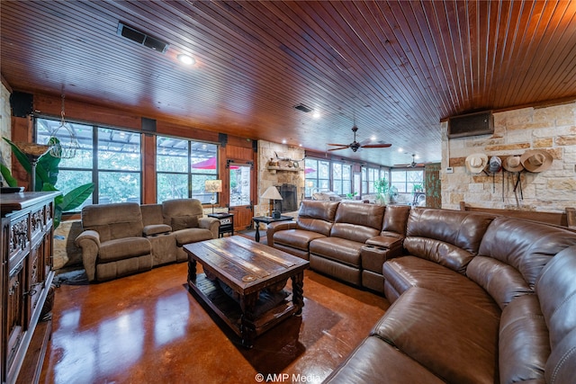 living room featuring a wealth of natural light, ceiling fan, wood ceiling, and concrete floors