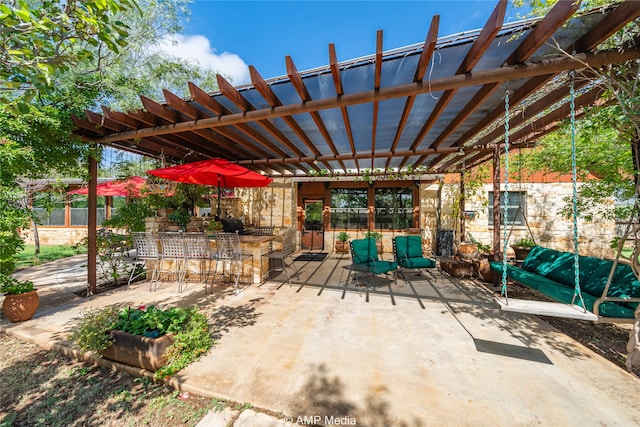 view of patio / terrace featuring exterior bar and a pergola