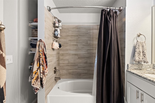 bathroom featuring vanity, a textured ceiling, and shower / bath combo