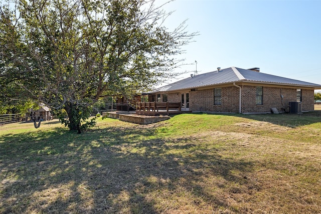 view of yard with central AC unit and a patio