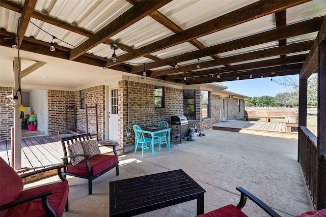 view of patio with a wooden deck and grilling area