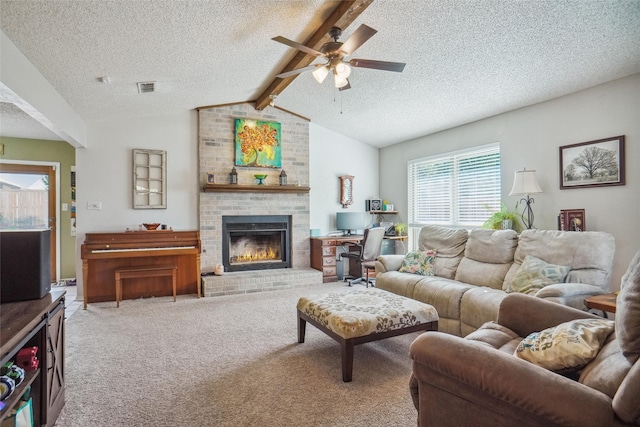 living room with carpet flooring, ceiling fan, a brick fireplace, lofted ceiling with beams, and a textured ceiling