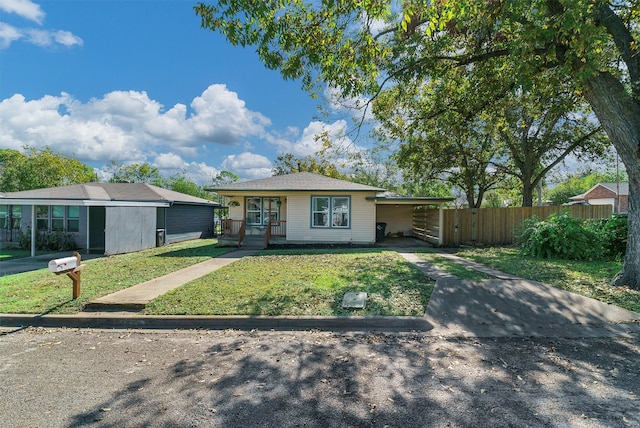 single story home featuring a porch and a front yard