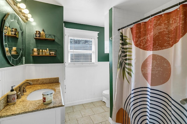 bathroom featuring curtained shower, vanity, and toilet