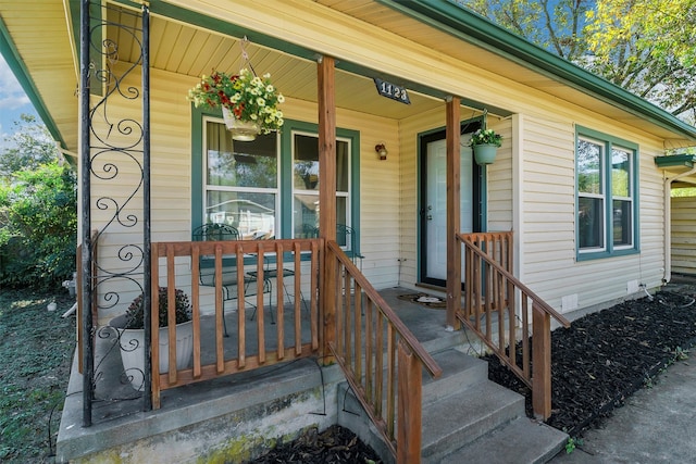 view of exterior entry featuring a porch