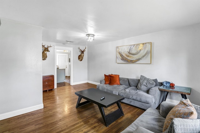 living room with dark hardwood / wood-style flooring