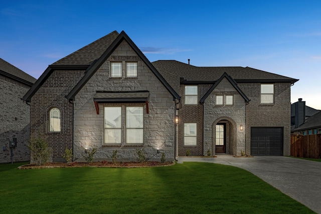 view of front of home featuring driveway, brick siding, a front yard, and a shingled roof