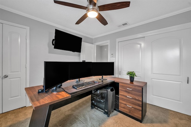 home office featuring ceiling fan, crown molding, light colored carpet, and a textured ceiling