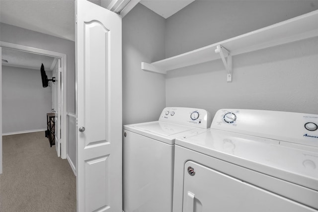 washroom featuring separate washer and dryer and light colored carpet