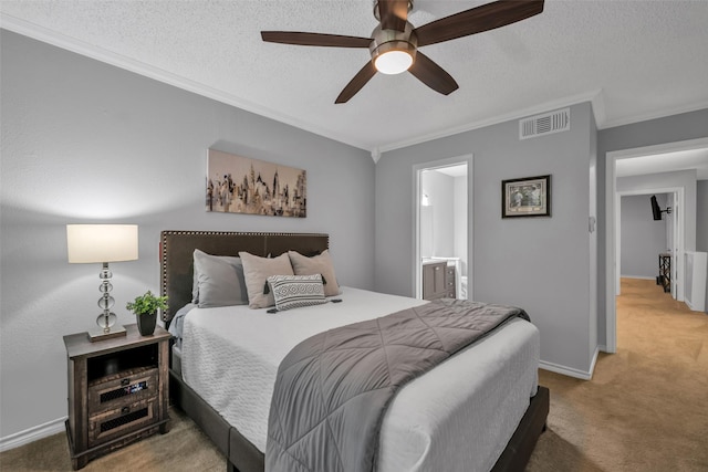 bedroom with carpet, ensuite bath, ceiling fan, and crown molding