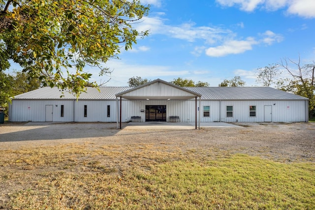 back of property featuring a yard