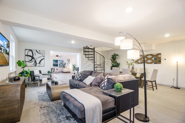 living room with hardwood / wood-style flooring and ceiling fan