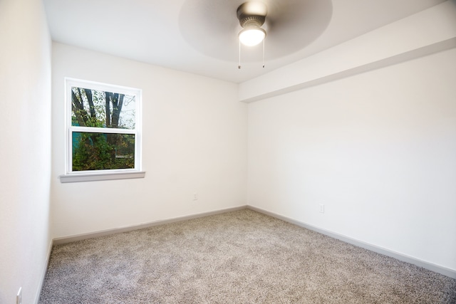 unfurnished room with ceiling fan and carpet