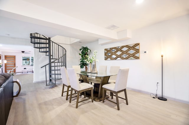 dining space featuring ceiling fan and light wood-type flooring