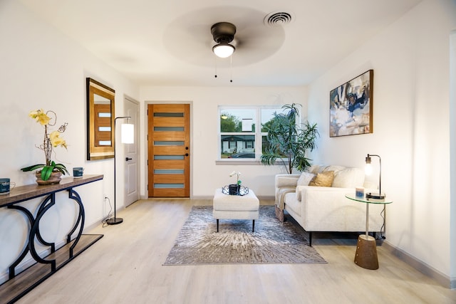 living area featuring ceiling fan and light hardwood / wood-style flooring