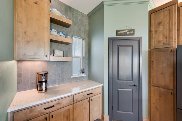 kitchen with light stone countertops and backsplash