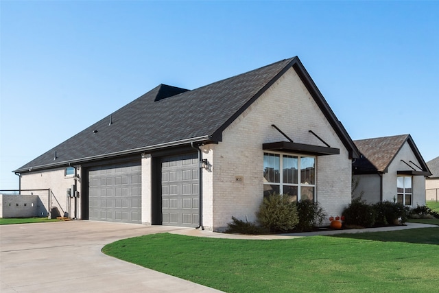 view of front of house with a garage and a front lawn