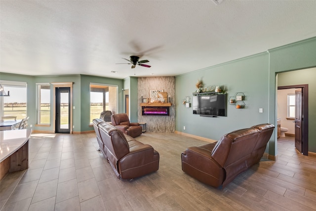 living room with a textured ceiling, hardwood / wood-style flooring, and ceiling fan