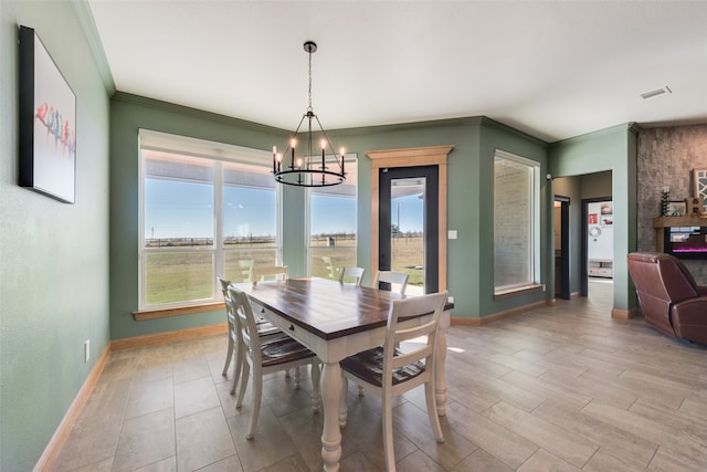 dining space featuring an inviting chandelier and crown molding