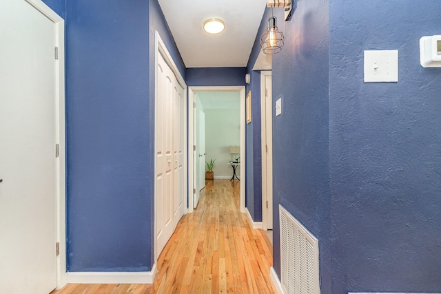 hallway with light hardwood / wood-style flooring