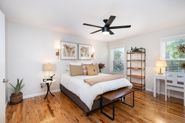 bedroom with ceiling fan and light hardwood / wood-style floors