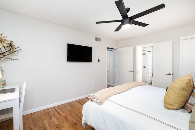 bedroom featuring hardwood / wood-style flooring, ensuite bath, and ceiling fan