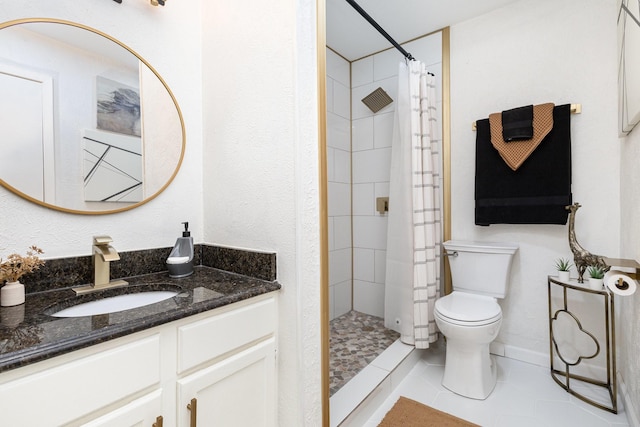 bathroom featuring tile patterned floors, curtained shower, vanity, and toilet