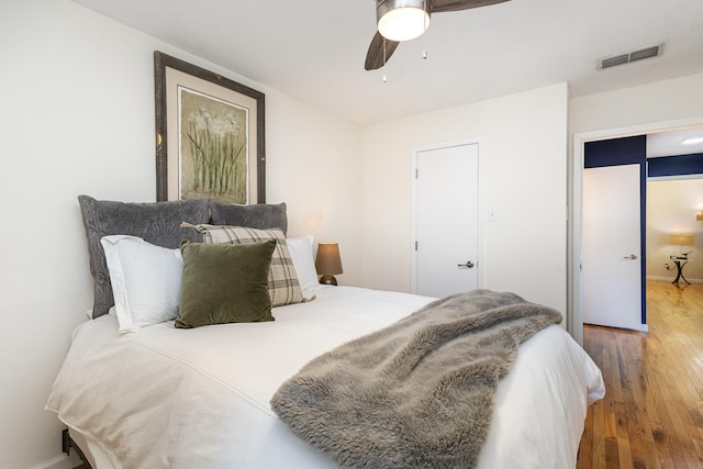 bedroom with hardwood / wood-style floors and ceiling fan