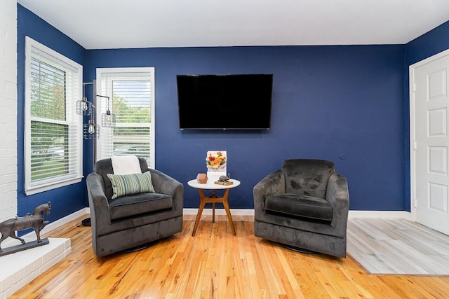 sitting room with wood-type flooring