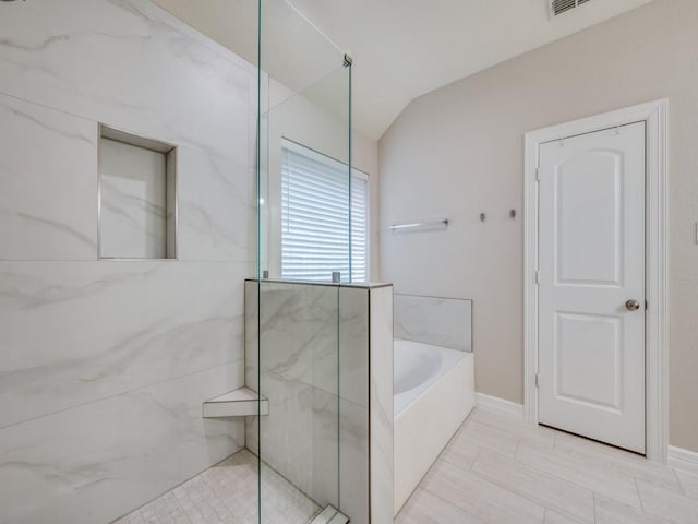 bathroom with separate shower and tub and vaulted ceiling