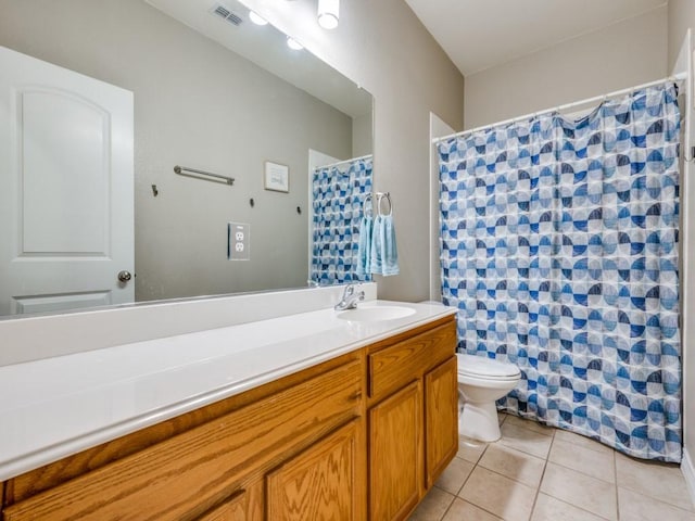 bathroom with tile patterned flooring, vanity, and toilet