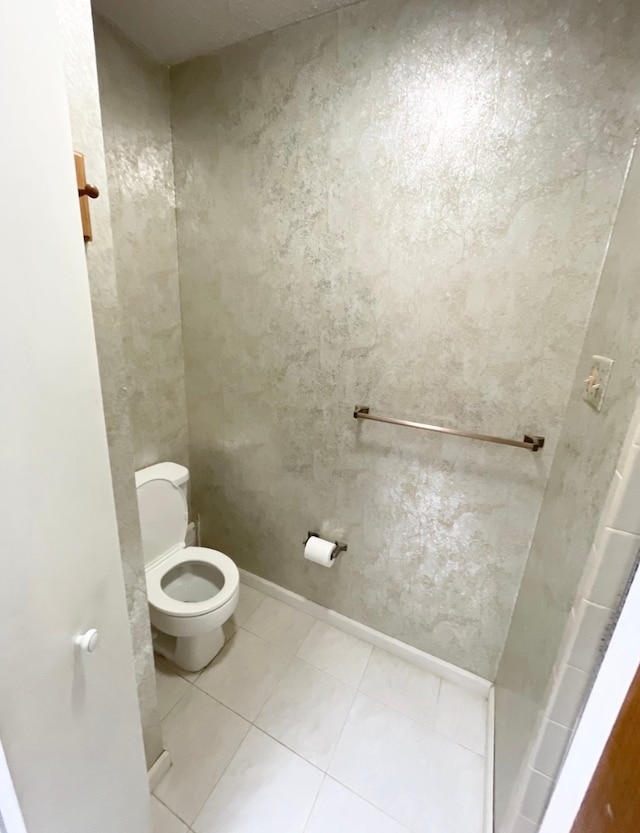 bathroom featuring tile patterned flooring and toilet