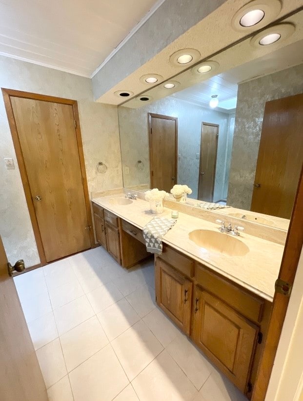 bathroom with vanity, tile patterned flooring, and ornamental molding