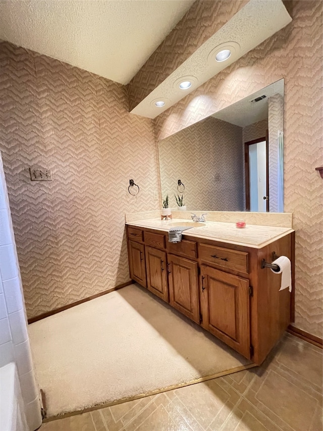 bathroom featuring vanity and a textured ceiling