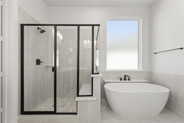 bathroom with plenty of natural light and shower with separate bathtub