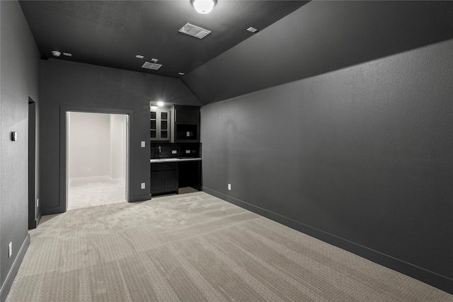 cinema with light carpet, visible vents, and baseboards