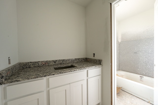 bathroom featuring vanity and a tub to relax in