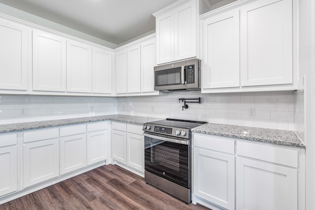kitchen with white cabinets, tasteful backsplash, stainless steel appliances, and dark wood-type flooring